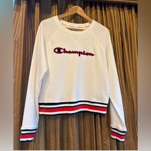 Medium white champion crewneck with hints of red and navy.